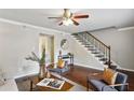 Bright living room with modern decor, hardwood floors, and a staircase at 29 La Rue Nw Pl, Atlanta, GA 30327