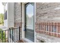 Gray front door with glass panel and black metal railing at 4249 Tacoma Trce, Suwanee, GA 30024