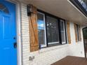 Bright blue front door, decorative exterior shutters, and charming brickwork details on facade at 2740 Flagstone Se Dr, Atlanta, GA 30316