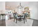 Chandelier-lit dining room with gold accents and barstool seating at kitchen counter at 2341 Brissett Ln, Brookhaven, GA 30319
