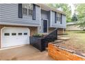 Close up of the house exterior, garage, and front flower bed at 3950 Yancey Rd, Douglasville, GA 30135