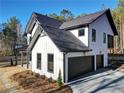 Beautiful two-story home with white siding, black trim, an attached garage, and a well-manicured lawn at 3785 Pilgrim Mill Rd, Cumming, GA 30041