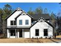 Charming two-story home with white siding, black trim, and a covered front porch at 3785 Pilgrim Mill Rd, Cumming, GA 30041