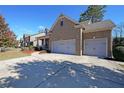 Brick house with a three-car garage and landscaped yard at 1079 Bar Harbor Pl, Lawrenceville, GA 30044