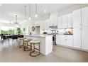 Bright kitchen with white cabinetry, quartz countertops, stainless steel appliances, and an island at 1641 Mcnaught Dr # 35, Atlanta, GA 30317