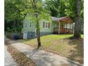Side view of the home featuring a quaint porch and lush green lawn at 1204 Westridge Sw Rd, Atlanta, GA 30311