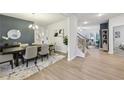 Elegant dining room with a large table, gray walls, and modern light fixture at 1451 Stephens View Dr, Loganville, GA 30052