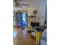 This living room offers hardwood floors and a brick fireplace and connects to the kitchen at 1685 Dogwood Trl, Douglasville, GA 30134