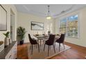 Inviting dining room featuring a modern table set, a bright window, and hardwood floors at 3298 Sheffield Cir, Decatur, GA 30032
