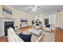 Bright living room with a fireplace, open to the kitchen with hardwood flooring at 3298 Sheffield Cir, Decatur, GA 30032