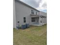 Home's back features a patio, two AC units and grassy yard at 5418 Flat Rock Pt, Stonecrest, GA 30038
