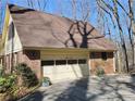 A spacious two-car garage with a neutral-colored door and brick siding at 25 Ridgeview Dr, Jonesboro, GA 30236