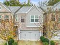 Inviting townhome showcasing brick and siding, a two-car garage, and well-maintained landscaping at 4429 Newfangle Rd, Stone Mountain, GA 30083