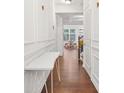 Bright hallway with hardwood floors and decorative white trim at 4429 Newfangle Rd, Stone Mountain, GA 30083