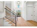 Bright and airy entryway with hardwood floors, a staircase, and large windows at 3225 Greenfield Dr, Marietta, GA 30068