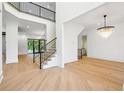 Open concept entryway with hardwood floors, a grand staircase, and chandelier at 3225 Greenfield Dr, Marietta, GA 30068