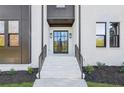 Modern home exterior with white brick, dark accents, and a stylish front door at 3225 Greenfield Dr, Marietta, GA 30068