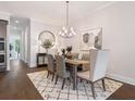 Well-lit dining room featuring a modern chandelier and stylish decor at 308 Thistle Ct, Woodstock, GA 30189