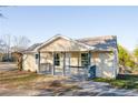 Inviting single-story home with a cozy front porch and freshly painted light yellow exterior at 2502 Park Dr, Lithonia, GA 30058
