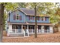 Two-story house with wrap around porch, shutters and landscaping at 101 Emily Ln, Carrollton, GA 30116