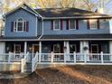 Two-story house with a wraparound porch and gray siding at 101 Emily Ln, Carrollton, GA 30116