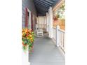 Relaxing front porch with rocking chairs, curtains and colorful flowers at 101 Emily Ln, Carrollton, GA 30116