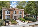 Brick apartment building with manicured landscaping and a clear walkway, presenting a welcoming facade at 242 12Th Ne St # 14, Atlanta, GA 30309
