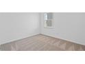 Neutral bedroom with gray carpet and a bright window offers a serene and calm space at 3087 Birdsong Ave, Covington, GA 30016