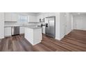 Modern kitchen with white cabinets, stainless steel appliances, and a granite island at 3087 Birdsong Ave, Covington, GA 30016