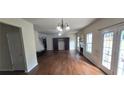 Bright living room featuring hardwood floors, a fireplace, and french doors to the backyard at 102 Ozark Trl, Canton, GA 30114