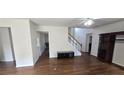 Spacious living room with hardwood floors, staircase, and a built-in entertainment center at 102 Ozark Trl, Canton, GA 30114