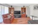 Living room with hardwood floors, built-in shelving, and comfy seating at 276 Lakemoore Ne Dr # E, Atlanta, GA 30342