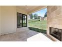 Covered patio has travertine floors, stone fireplace and an open view to the backyard at 3785 Lower Roswell Rd, Marietta, GA 30068