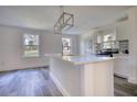 Modern kitchen with white cabinets, quartz countertops, and a large island at 773 Harwell Nw Rd, Atlanta, GA 30318