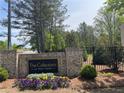 The Collections at Wolf Creek community sign with flowerbed and brick and ironwork at 1267 Lucan Nw Ln # Wc217, Lawrenceville, GA 30043