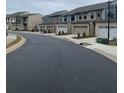 Street view of townhomes with attached garages and landscaping at 1267 Lucan Nw Ln # Wc217, Lawrenceville, GA 30043
