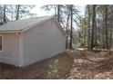 Side view of a newly renovated house with a wooded backdrop at 650 Fairforest Ct, Stone Mountain, GA 30088