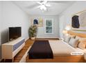 Bedroom with wooden floors, a bed, dresser and view of the backyard at 3549 Meadow Chase Dr, Marietta, GA 30062