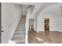 Inviting foyer with wood-look floors, carpeted stairs, and an open layout to the living spaces at 621 Kenridge Way # 0, Suwanee, GA 30024