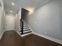 Modern staircase with dark hardwood floors and white risers at 700 Banton Nw Dr, Atlanta, GA 30318
