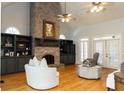 Spacious living room featuring a brick fireplace, built-in shelving, and vaulted ceiling at 86 Waterford Path, Hiram, GA 30141