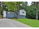 Charming home with a well-maintained lawn and fresh landscaping at 6914 Fairway Trl, Austell, GA 30168
