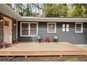 Relaxing front porch with pink door and two black chairs at 956 Cardova Dr, Atlanta, GA 30324