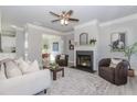 Comfortable living room features a fireplace, ceiling fan, neutral colors, and stylish decor at 6478 Beaver Creek Trl, Atlanta, GA 30349