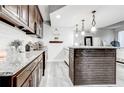 Modern kitchen featuring granite countertops, stainless steel appliances, and stylish lighting at 5483 Wylstream, Norcross, GA 30093