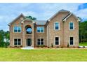 Stunning two-story brick home with manicured lawn and inviting front entrance at 5380 Deer Run Dr, Conyers, GA 30094