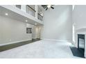 Open-concept living room boasts soaring ceilings, fireplace, and natural light at 5380 Deer Run Dr, Conyers, GA 30094