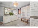 Elegant bathroom with double vanity, subway tile, and a patterned floor at 1384 Jefferson Ave, East Point, GA 30344