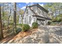 Attached garage with gray doors and landscaping at 2680 Spalding Dr, Sandy Springs, GA 30350