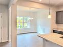 Bright dining area featuring large window and decorative trim, adjacent to the kitchen island at 4841 Walkers Green, Mableton, GA 30126